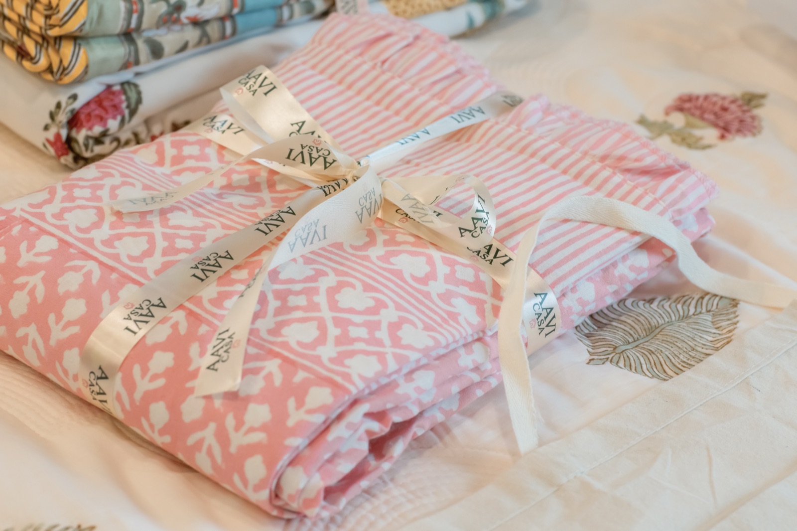 Folded block-print linens tied with AAVI CASA ribbon